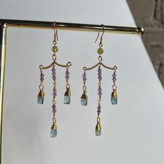 Stunning contemporary dangle earrings made with blue kyanite and amethyst. Earring posts are gold plated and hypoallergenic. Gold Amethyst Dangle Chandelier Earrings, Blue Amethyst Dangle Earrings, Chandelier Earrings Diy, Amethyst Earring, Beaded Stuff, Diy Earring, Syracuse Ny, Hand Making, Earrings Diy