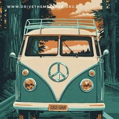 a vw bus driving down the road with trees in the background