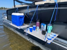 a blue cooler sitting on the back of a boat