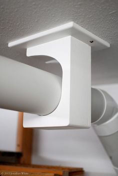 a close up of a light fixture on a ceiling in a room with white walls