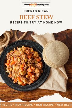 a plate filled with beef stew next to a tortilla on top of a wooden table