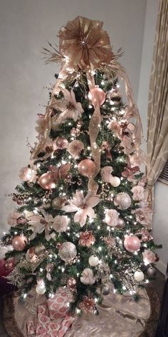 a decorated christmas tree with pink and gold ornaments