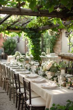 an outdoor dining area with tables and chairs set up for a formal dinner in the shade