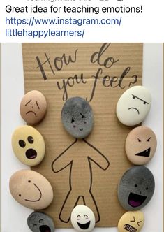 a cardboard sign that says how do you feel? surrounded by rocks with faces on them