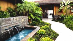 an image of a house with water coming out of the front door and landscaping around it