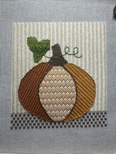 a close up of a piece of cloth with a pumpkin on it