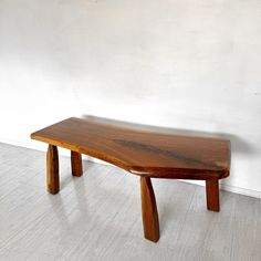 a wooden bench sitting on top of a white floor