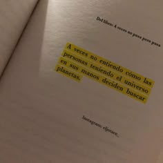 an open book with some yellow stickers on it's pages and the words in spanish