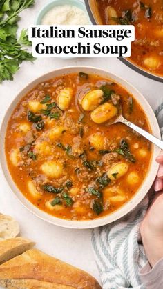 two bowls of italian sausage and gnocchi soup on a white table with bread