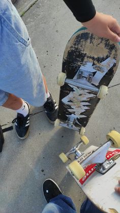 the skateboarder is trying to pull off his stunt on the street while another person watches