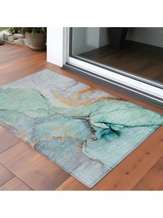 an area rug that has been placed on the floor in front of a sliding glass door