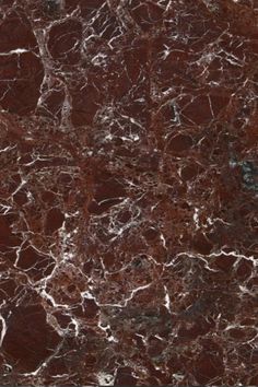 a brown and white marble textured wall or floor tile with dark red veining