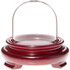 a red glass dish with a metal handle