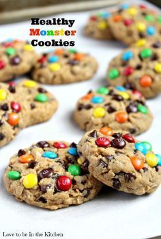 cookies with m & m's and chocolate chips are on a baking sheet, ready to be eaten