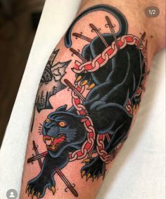 a man's arm with a black panther and chain tattoo on it, which has an arrow in the middle