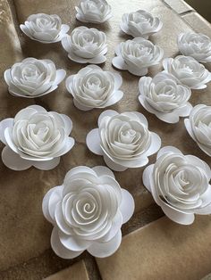 white paper flowers are arranged on a table