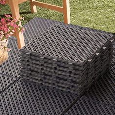 a table made out of legos sitting on top of a grass covered field next to a wooden chair