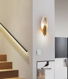 a living room with stairs and a television on the wall