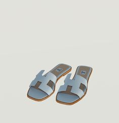 a pair of white sandals sitting on top of a floor