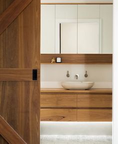 the instagram page shows an image of a bathroom with wooden cabinets and white sinks