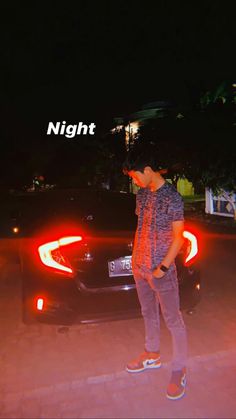 a man standing in front of a car with the word night on it's side