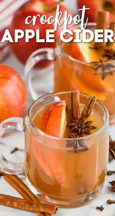 two mugs filled with apple cider and cinnamon sticks