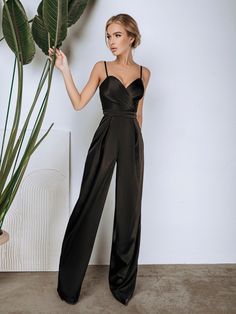 Black Jumpsuit Outfit Wedding Guest, Elegant Evening Jumpsuit With Spaghetti Straps, Elegant Jumpsuits And Rompers With Spaghetti Straps, Elegant Solid Color Backless Strapless Jumpsuit, Elegant Spaghetti Strap Jumpsuits And Rompers For Party, Elegant Party Jumpsuits With Spaghetti Straps, Black Satin Jumpsuit For Evening, Black Satin Evening Jumpsuit/romper, Chic Satin Jumpsuits And Rompers In Solid Color