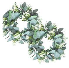 a wreath with white flowers and green leaves is shown on a white background for use as an ornament