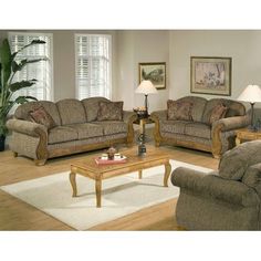 a living room with two couches and a coffee table in front of a fireplace