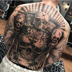 a man's back with skulls and cats on it