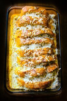 chicken parmesan bread in a casserole dish with melted cheese and pine nuts