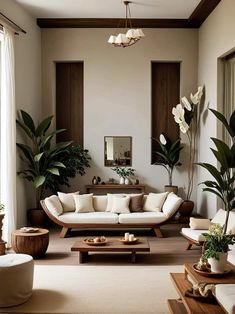 a living room filled with furniture and plants