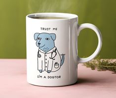 a white coffee mug with a blue dog on it and the words trust me, i'm a doctor