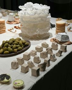 a table topped with lots of different types of cakes and desserts next to each other