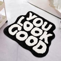 a black and white rug with the words you cook book on it