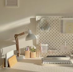 an old typewriter sitting on top of a desk next to a lamp and other items