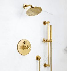 an image of a shower faucet with gold fixtures