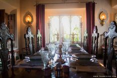 the dining room table is set with place settings