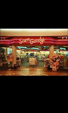 the entrance to sam's goody is lit up in red and white lights