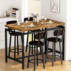 a kitchen table with four stools in front of it