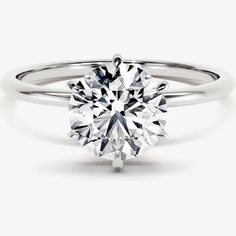 a round brilliant cut diamond engagement ring on a white background, with the center stone setting in