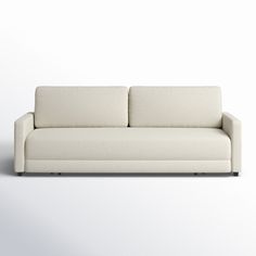 a white couch sitting on top of a white floor