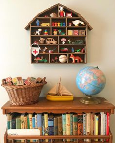 a bookshelf filled with lots of books and toys