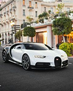 a white bugatti is parked on the street