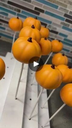 some oranges are on sticks with chocolate chips in them