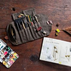 an artist's kit is sitting on a wooden table