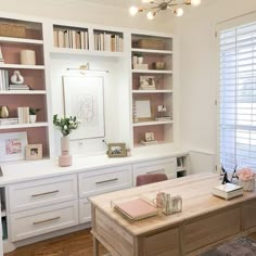 an office with white cabinets and pink accents