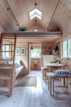 the interior of a tiny cabin with wooden walls and ceilings