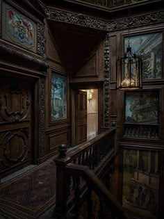 an old wooden staircase with paintings on the walls