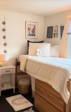 a bed room with a neatly made bed next to a window and a night stand